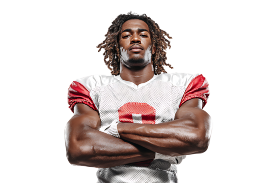 A muscular african american football player with dreadlocks stands with his arms crossed, isolated on a transparent background