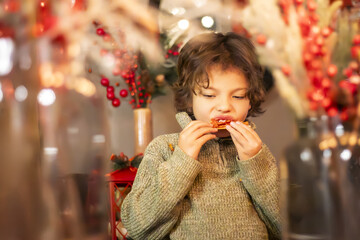 A cute boy enjoying a pizza snack during a cozy christmas event