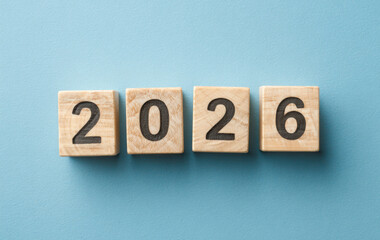 2026 Written with Wooden Cubes on Blue Background