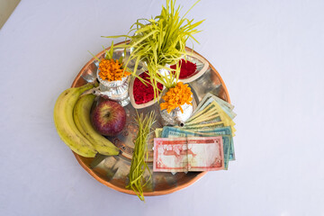 Tika and Jamara placed in a silver utensil with barley sprouts, money, and fruits for the Vijaya Dashami ceremony during Dashain festival in Nepal.
