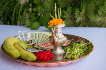 Tika and Jamara placed in a silver utensil with barley sprouts, money, and fruits for the Vijaya Dashami ceremony during Dashain festival in Nepal.