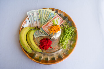 Tika and Jamara placed in a silver utensil with barley sprouts, money, and fruits for the Vijaya Dashami ceremony during Dashain festival in Nepal.