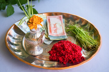 Tika and Jamara placed in a silver utensil with barley sprouts, money, and fruits for the Vijaya Dashami ceremony during Dashain festival in Nepal.