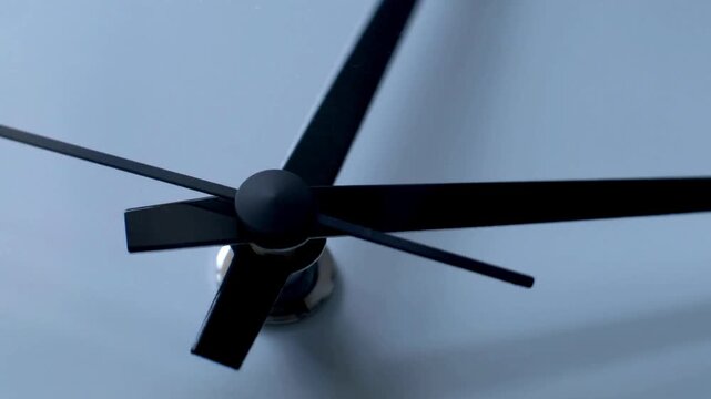 Close up a wall clock arrow showing hour and minute hand moving clockwise running on time pointer