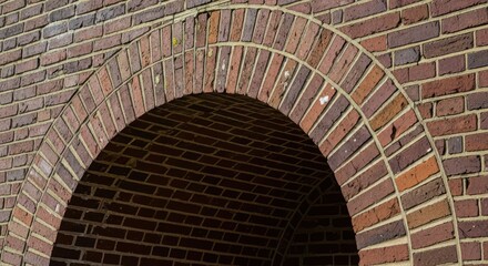 Brick archway detail on a wall surface of a vintage building facade