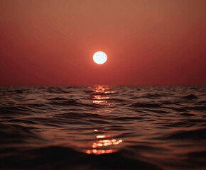 Vibrant sunset paints the ocean with golden light, creating a tranquil and breathtaking seascape.