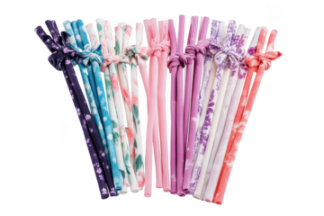 Reusable silicone straws set with floral patterned fabric ties, eco-friendly drinking straws for beverages, colorful set isolated on transparent background