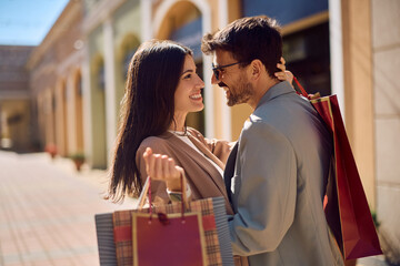 Affectionate couple enjoying in their shopping day together.