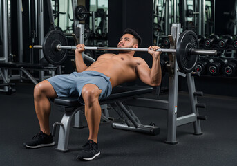 Fototapeta premium Strong Man Doing Bench Press Workout in Modern Gym