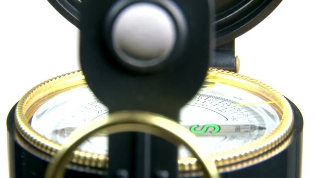 metal compass in hand. terrain orientation. arrow mechanism. circular dial. Close up view of the compass. Tourism, traveling, hiking and healthy lifestyle concept.