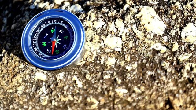 Compass with rock background. round compass on natural background as symbol of tourism with compass and travel with compass and outdoor activities with compass.
