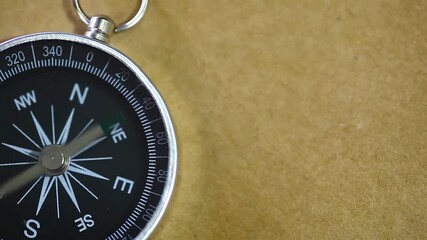 compass as symbol of tourism, travel and outdoor activities. Finding your way with a compass. Closeup view of compass. Tourism, traveling, hiking and healthy lifestyle concept. - Powered by Adobe