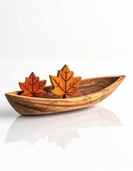 Wooden leaves in boat-shaped bowl against white background