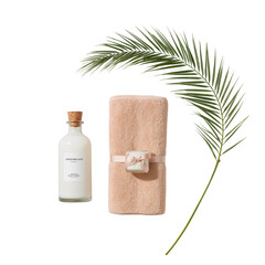 Elegant bath arrangement with linen, lotion and tropical leaf against a dark backdrop