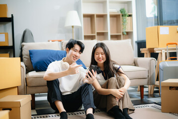 Young couple organizing belongings in a cozy home with boxes and luggage. Perfect for themes of moving