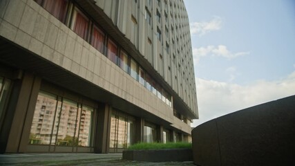 Slowmo shot of young Caucasian guy performing somersault while freerunning in urban environment at daytime - Powered by Adobe