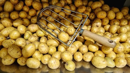 young potatoes in a box on a market window with a shovel for picking potatoes