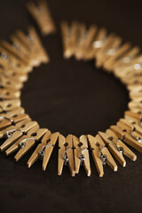Creative Circular Arrangement of Wooden Clothespins on Dark Background