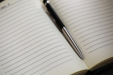 Open Notebook with Lined Pages and Pen for Writing and Note-Taking Concepts