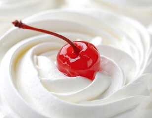 Close-up of a creamy white dessert with a red cherry