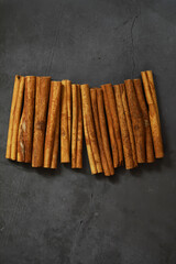 Cinnamon Sticks on Dark Stone Background: Aromatic Spice Display in Stock Photography