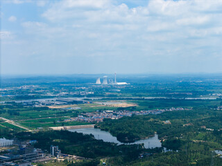 Suizhou City Hubei Province China landscape with industrial cooling towers visible in the distance under a cloudy sky.