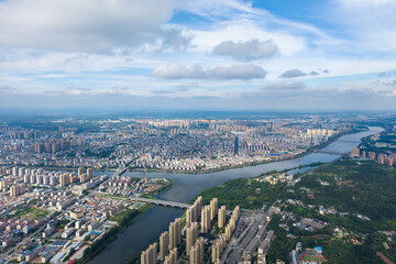 Obraz premium Suizhou City Hubei Province China cityscape vista shows vast urban sprawl and a river winding through the densely built environment under a cloudy sky.