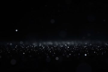 A dimly lit surface covered with glittering specks against a dark and blurry background scene view
