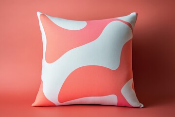 A square decorative pillow displays a striking abstract pattern of soft coral and off-white, creating a vibrant and contemporary aesthetic.