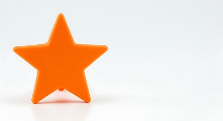 Obraz premium Orange star shape on white background with copy space for design elements