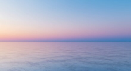 Obraz premium Tranquil ocean scene with gradient sky reflecting on calm water surface