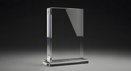 A clear, blank rectangular crystal glass award or trophy plaque standing upright on a dark, reflective surface, perfect for adding custom text or logos
