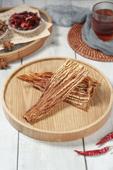 Dried bamboo shoots on bamboo plate with tea and Asian spices for traditional cooking