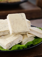Fresh Tofu Slices on Iron Plate with Lettuce - Asian Cooking Ingredient