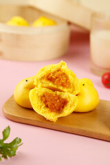 Colorful Yellow Steamed Buns with Orange Filling - Fancy Dim Sum Dumplings on Wooden Board