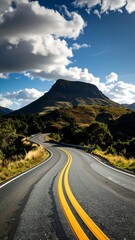 Naklejka premium Winding mountain road under a cloudy sky