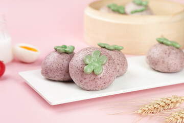 Purple Steamed Buns with Green Flower Decorations on Pink Background - Asian Cuisine Food Photography