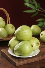 Fresh Guangxi Guavas on Wooden Table - Tropical Heart-Shaped Fruit with Soft Cream Flesh