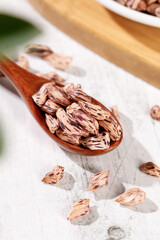 Appetizing Pinto Beans in Wooden Spoon - Colorful Legume Kernels on Rustic Kitchen Surface