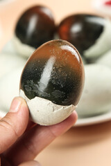 Traditional Gaoyou Preserved Century Eggs Chinese Cuisine Delicacy Hand Holding Dark Translucent Egg