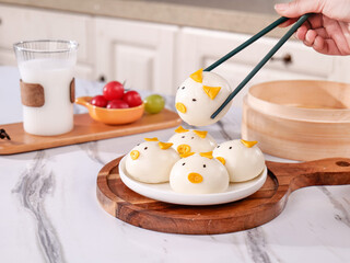 Adorable Pig-Shaped Steamed Buns Dim Sum with Chopsticks in Kitchen Setting
