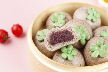 Festive Purple-Filled Steamed Buns with Shamrock Decorations in Bamboo Steamer for St. Patrick's Day