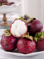 Fresh Mangosteen Fruit from Thailand with White Flesh Segments on Plate