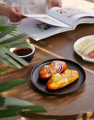 Glazed Stuffed Pastries with Coffee and Magazine Reading Morning Breakfast Scene