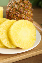 Fresh Golden Pineapple Slices with Whole Fruit Showing Sweet Yellow Flesh and Diamond Pattern Texture