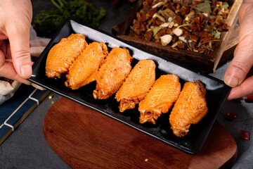 Grilled Marinated Chicken Wings on Black Plate Ready to Eat