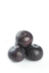 Fresh Queen Rosa Plums with Dark Purple Skin and Red Flesh on White Background