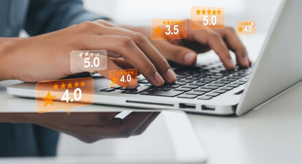 Close-up of hands typing on laptop with star ratings overlay. Person actively working on sleek silver laptop with review scores. Professional workspace with digital rating graphics on keyboard.