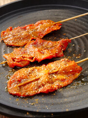 Grilled Beef Tenderloin Skewers Cooking on Pan with Sesame Seeds and Spices