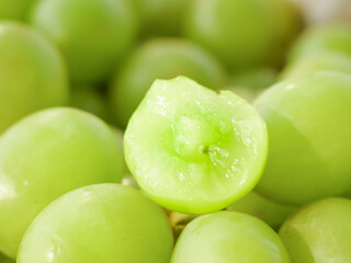 Fresh Green Grapes Close-Up with Cut Half Showing Interior Detail